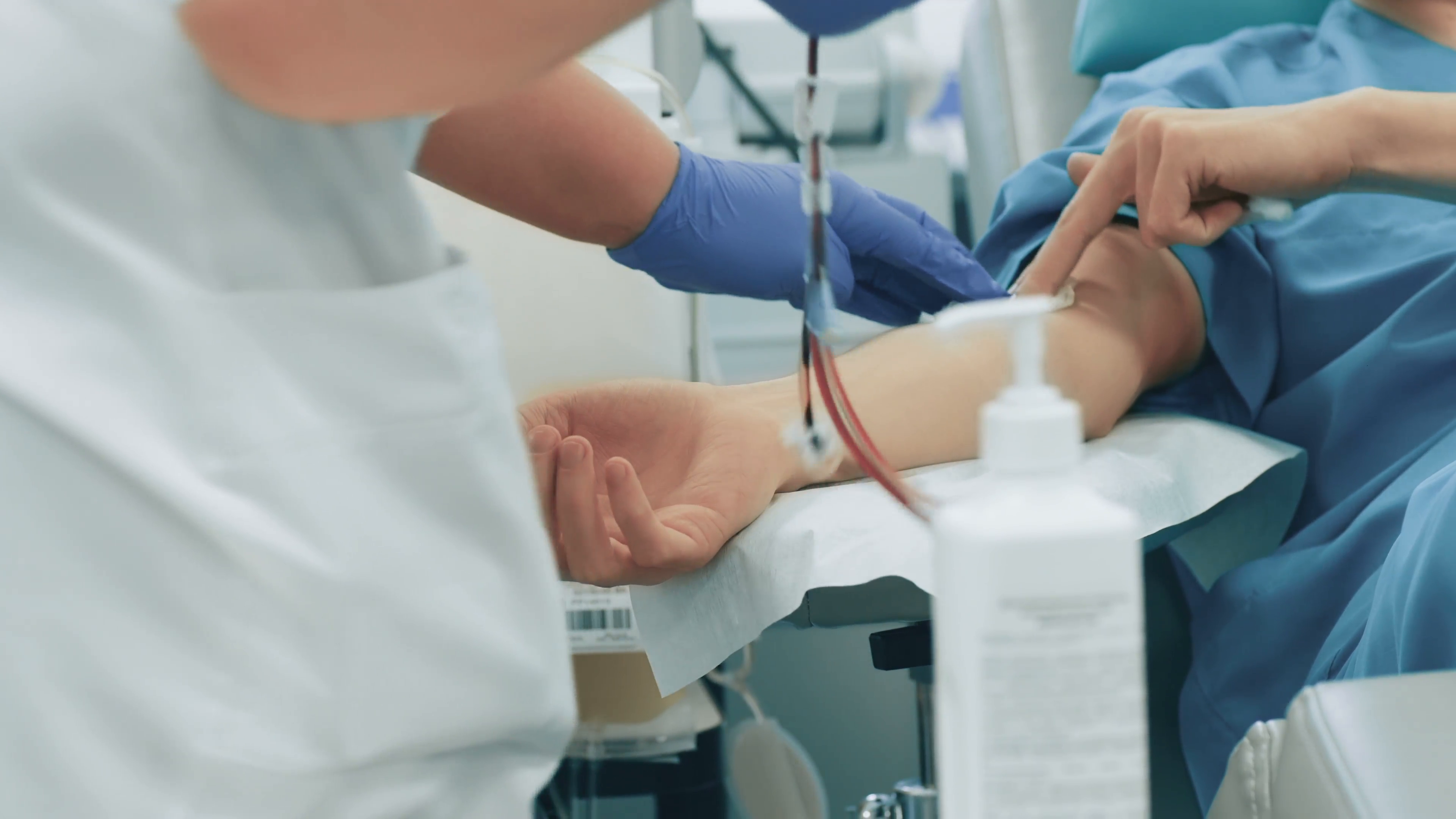 nurse-removes-the-needle-after-giving-blood-donation-in-hospital_vjitadf9l__F0009